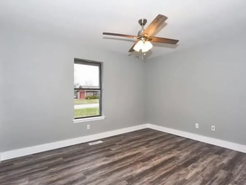 Bedroom after remodel with improved finish continuity and brighter tone