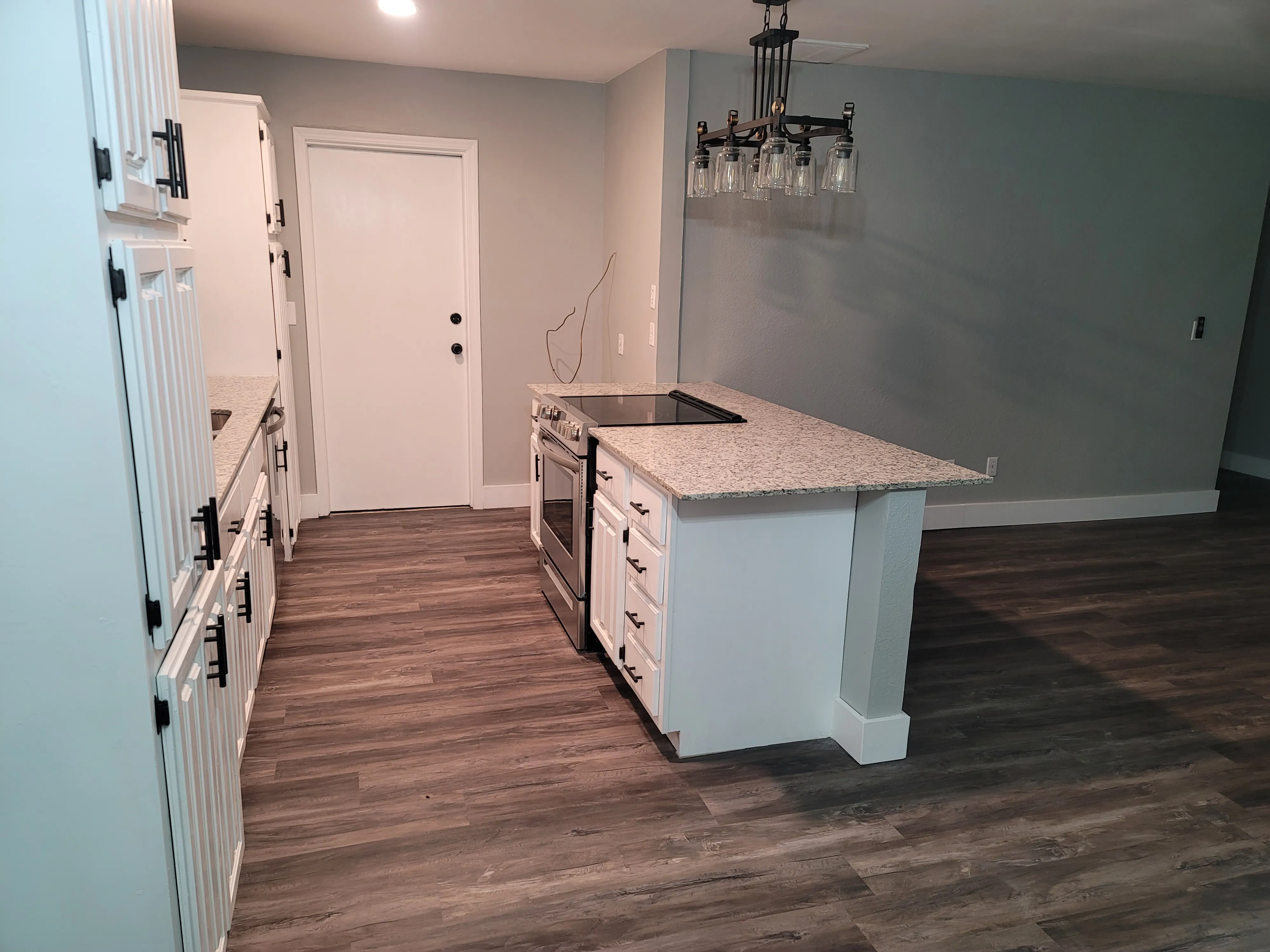 Kitchen detail after remodel with updated counters and brighter finish package