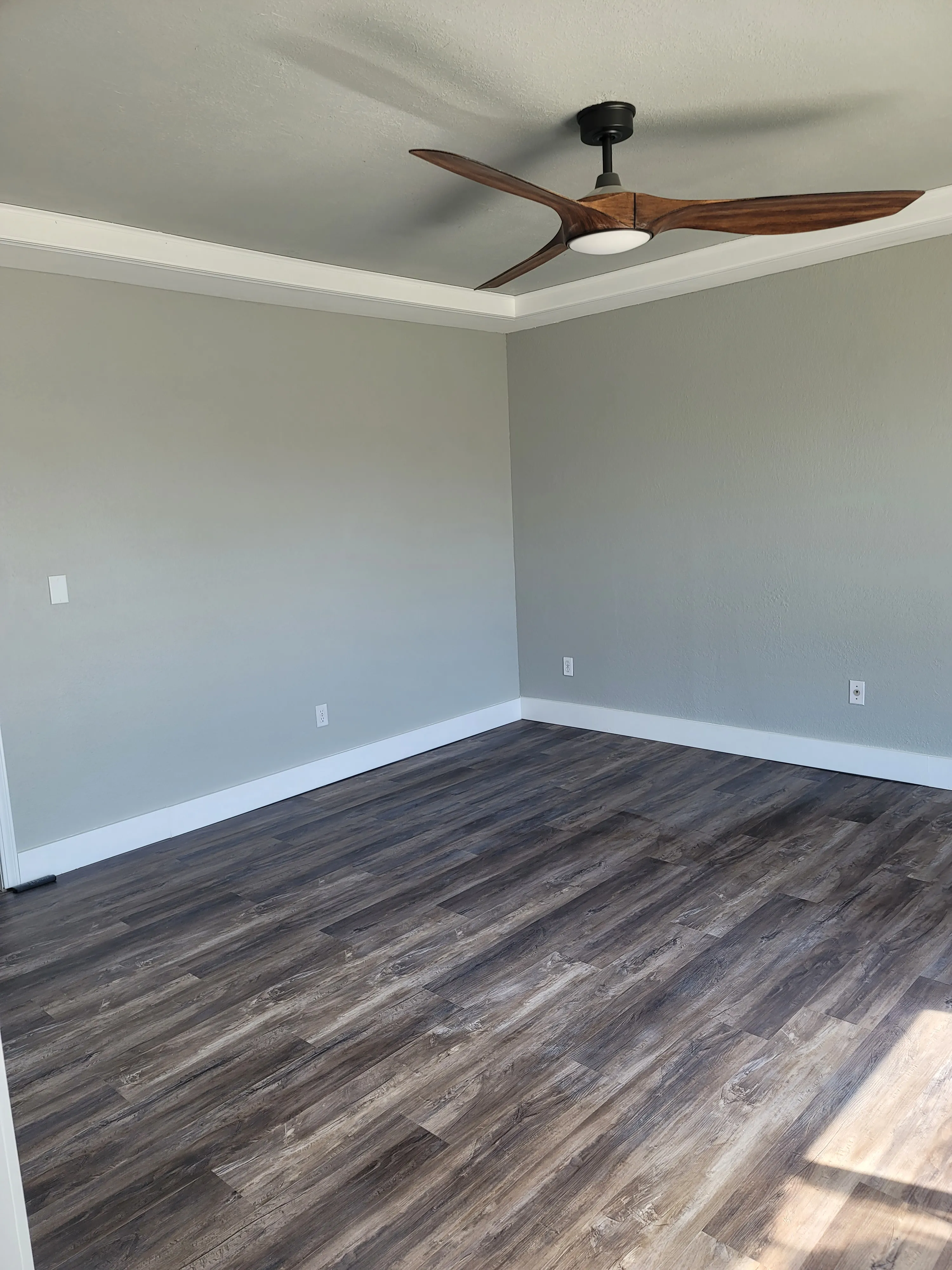 Finished master bedroom after remodeling with updated finishes and a wider view of the space.