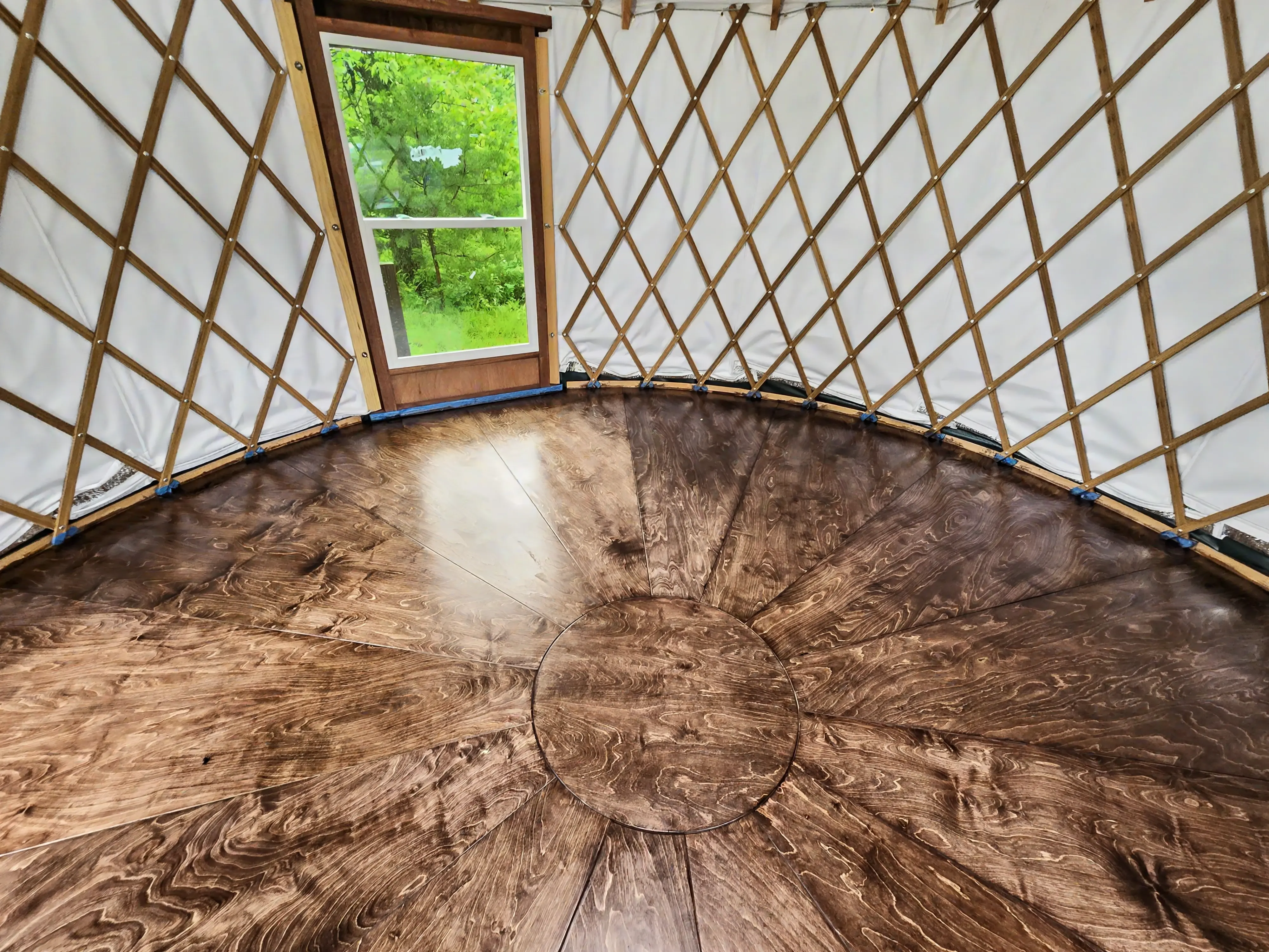 Custom wood floor installation inside a Tulsa-area yurt build